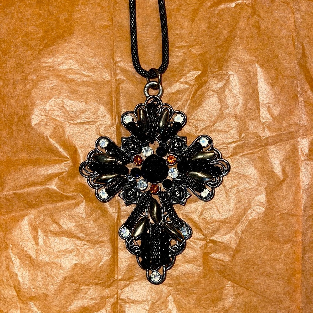 Heavy necklace, cross with rose in the middle. Orange, black and white stones.